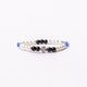 Brǎțarǎ elastic bile perlǎ si cruce metal.  AB100set